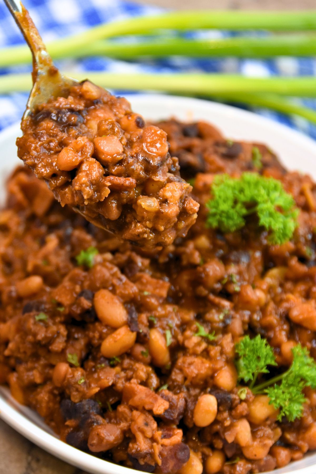 Ready-to-eat-baeked-beans-with-ground-beef Brown glossy baked beans with ground beef.