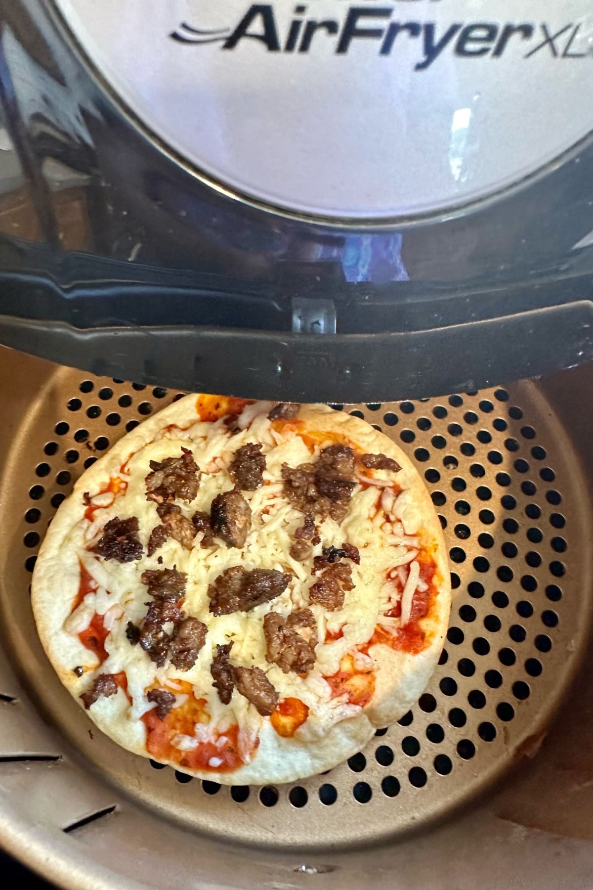 Tortilla Pizza coming out of the air fryer. 