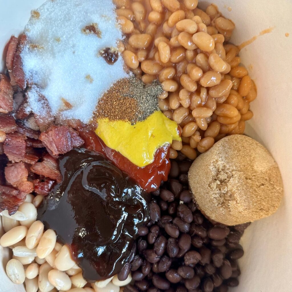 adding-all-the-seasoning-and-sauce-into-the-pot Ingredients for southern baked beans.
