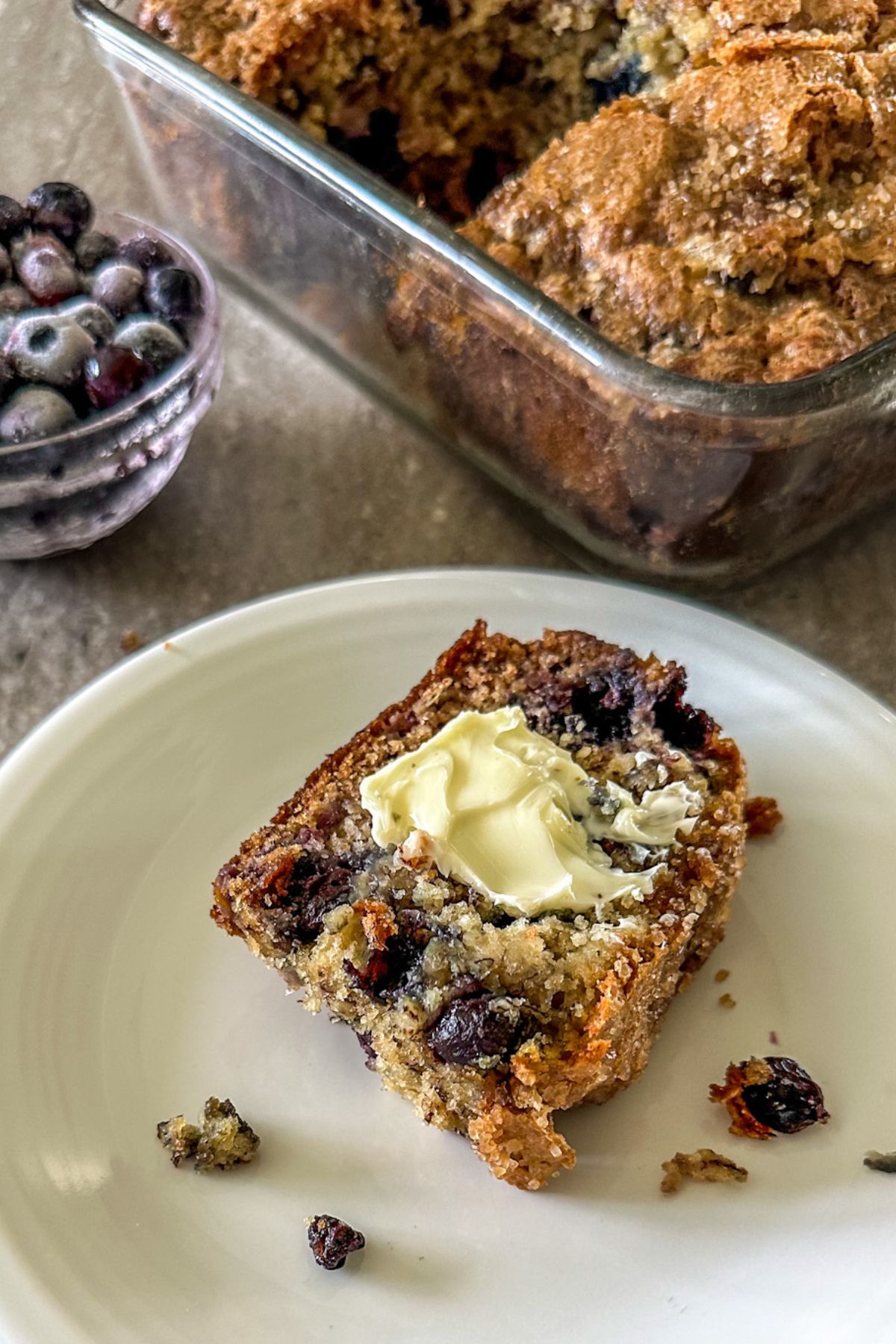 Slice of Blueberry Banana Bread with butter. 
