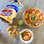 Pan of Corn Dip with Cream Cheese with spoon.