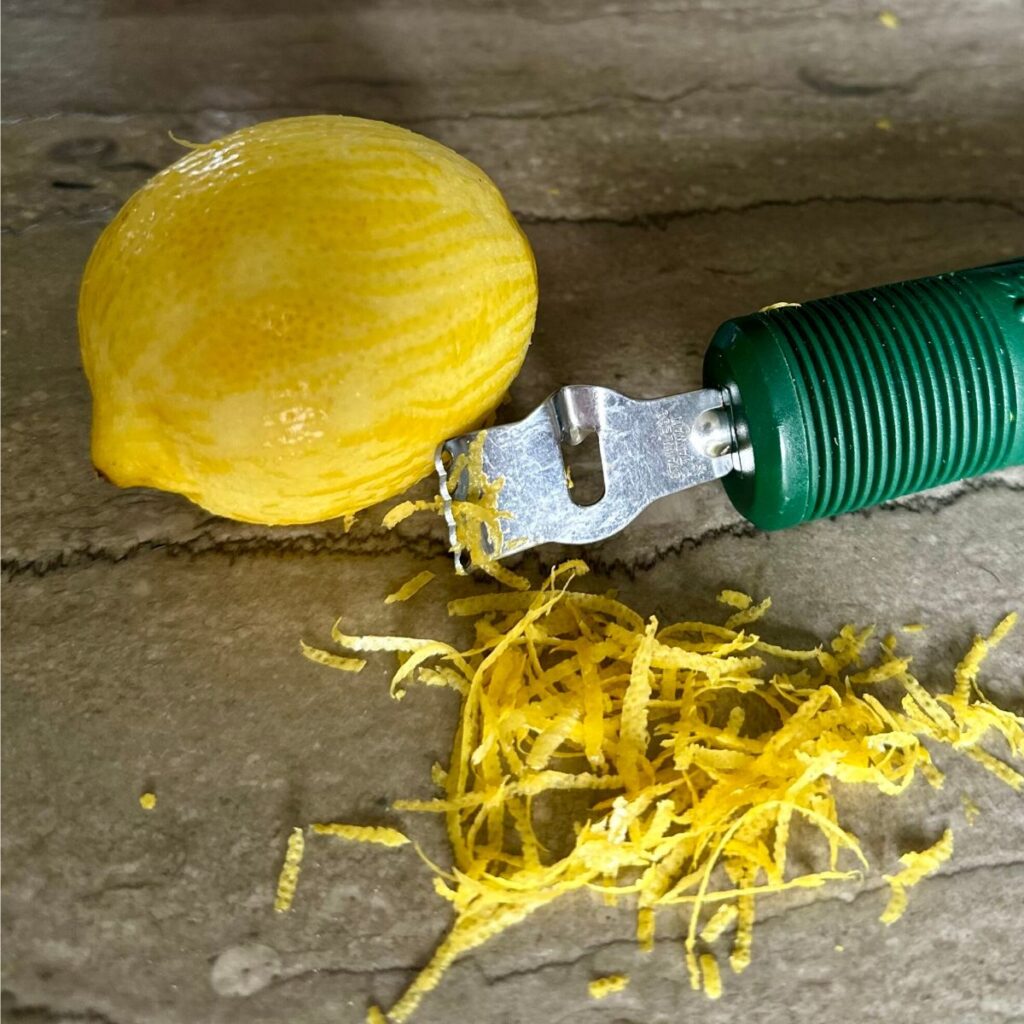 zest-the-lemon Lemon zest with lemon and zester.