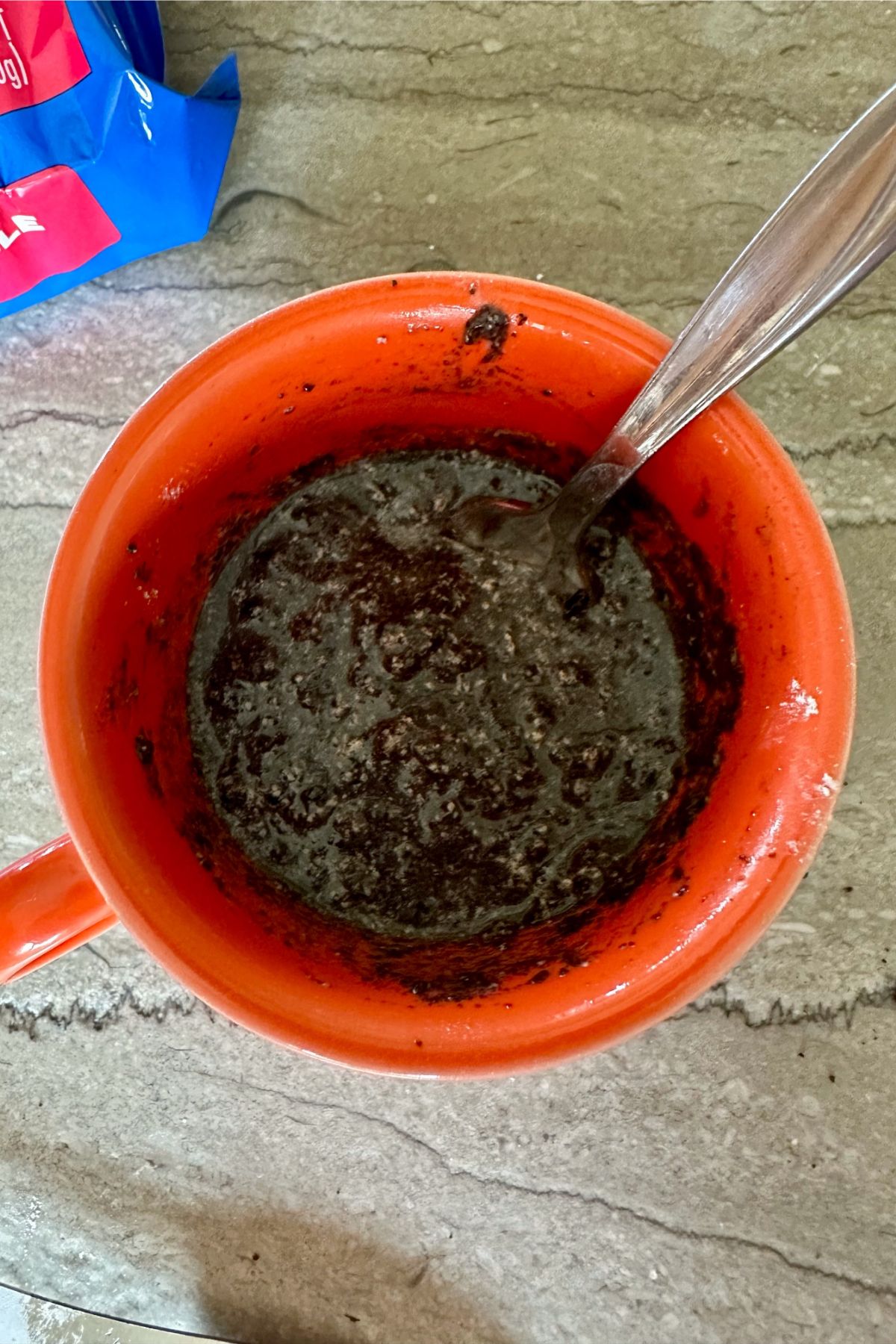 Oreo Mug Cake ingredients stirred in a mug.