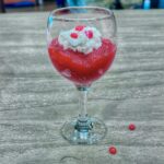 Jello Applesauce in wine glass with whipped cream.