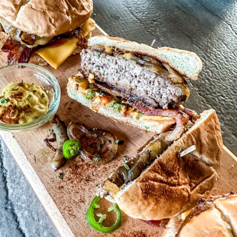 Sweet and Spicy Bacon Burger cut in half.