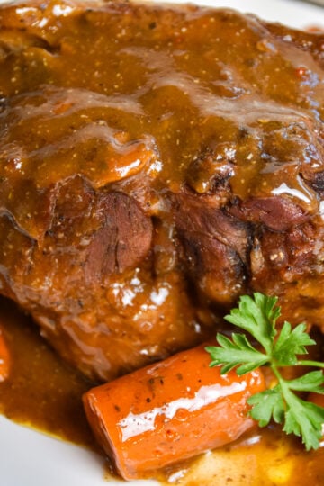 Finished beef pot roast with seasonings.