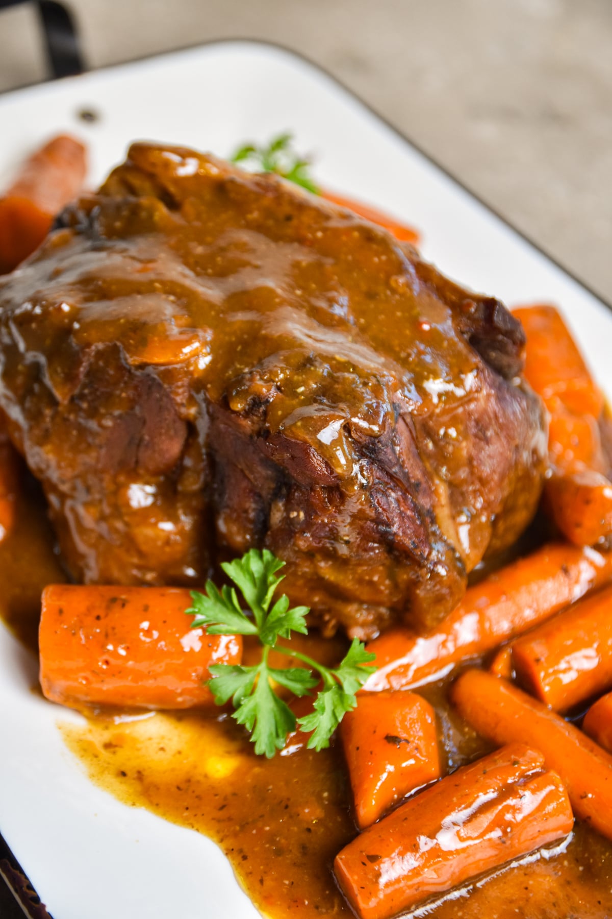 pot-roast-gravy Pot roast seasoned and cooked served on a platter.