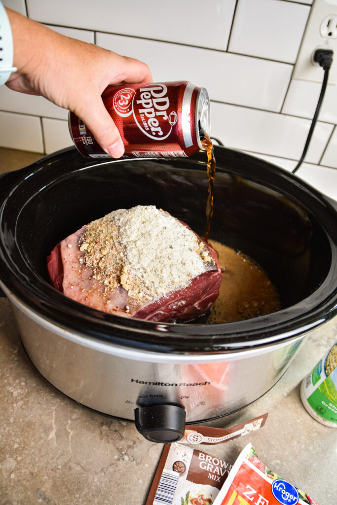 Putting seasonings on pot roast.