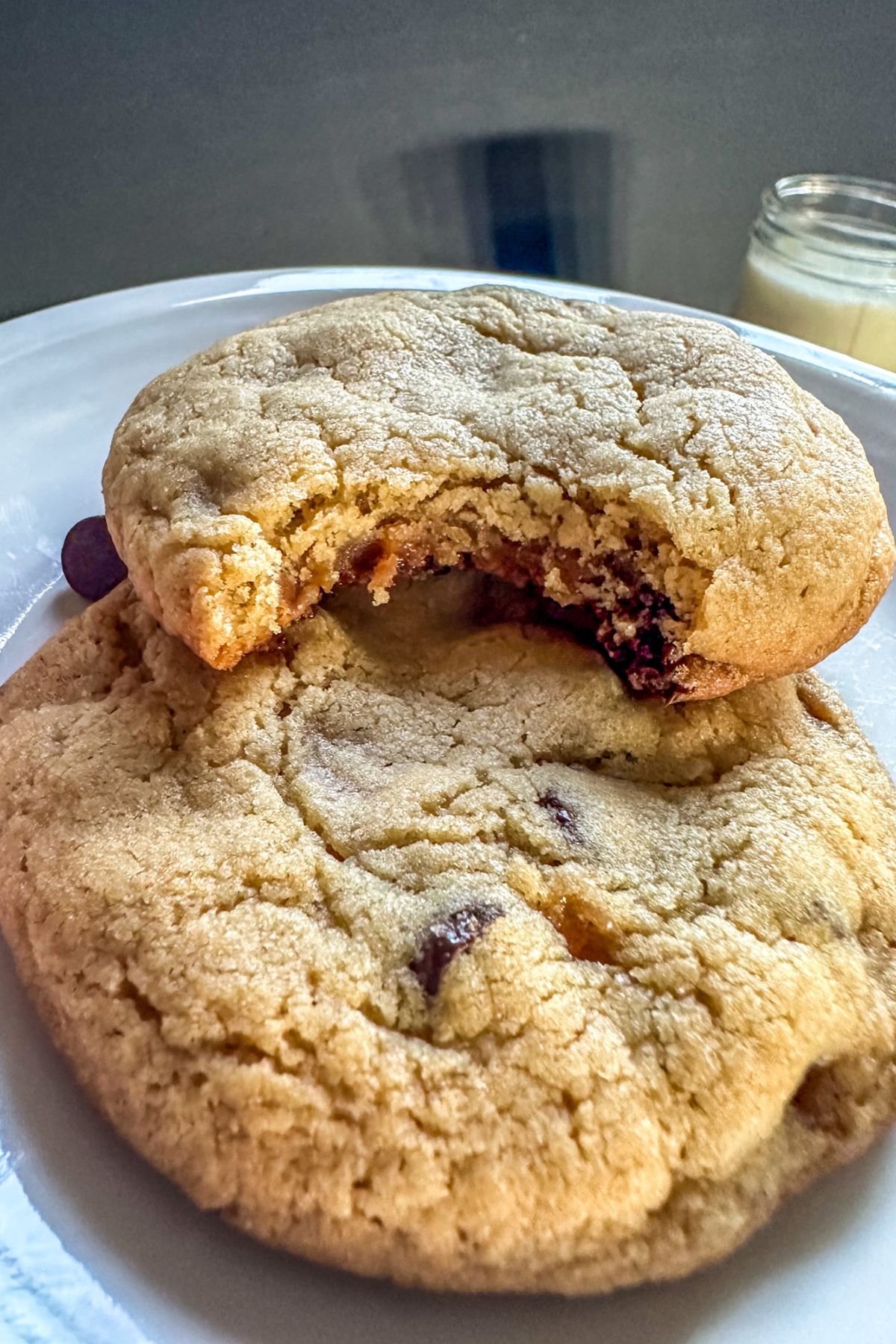 Two Caramel Chocolate Chip Cookies stacked on top of one another. 
