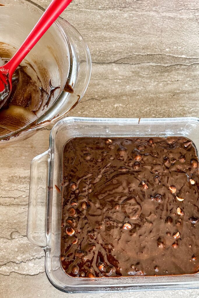 Espresso brownie batter added to a backing dish. 