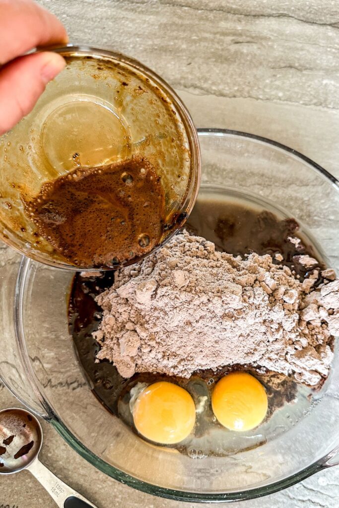 Adding ingredients to Espresso Brownie mixture in a bowl. 