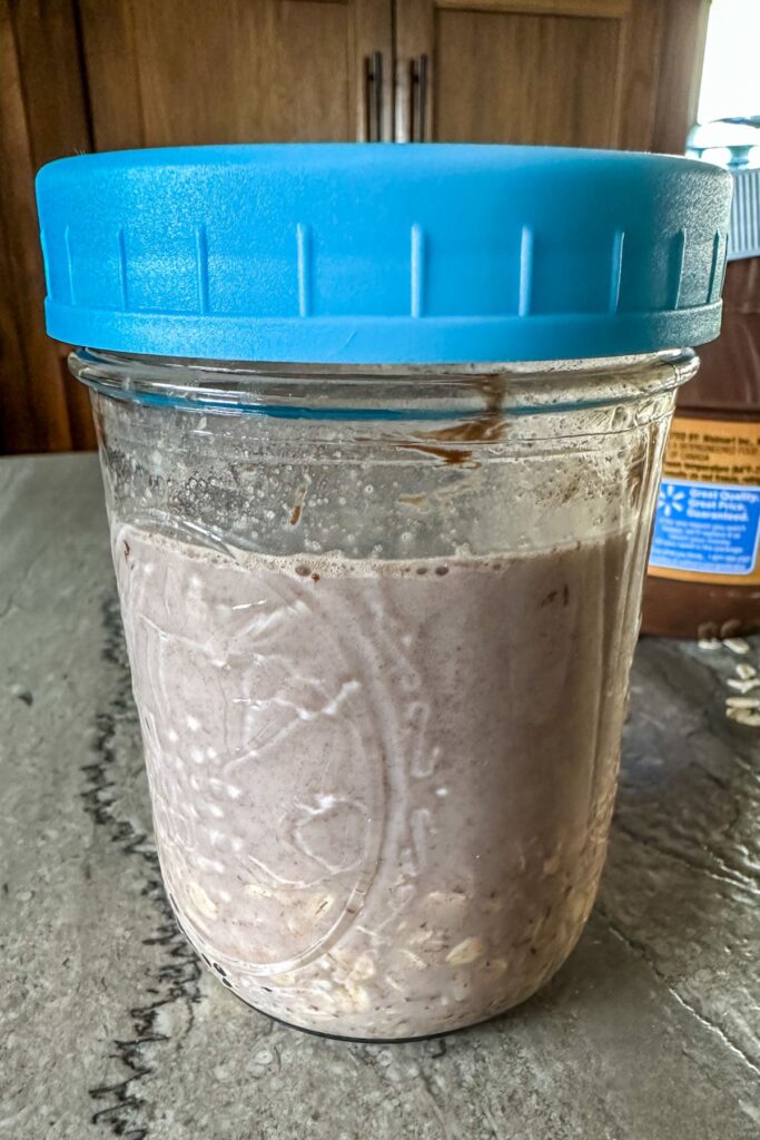 Blended Nutella Overnight Oats in a jar with a lid.