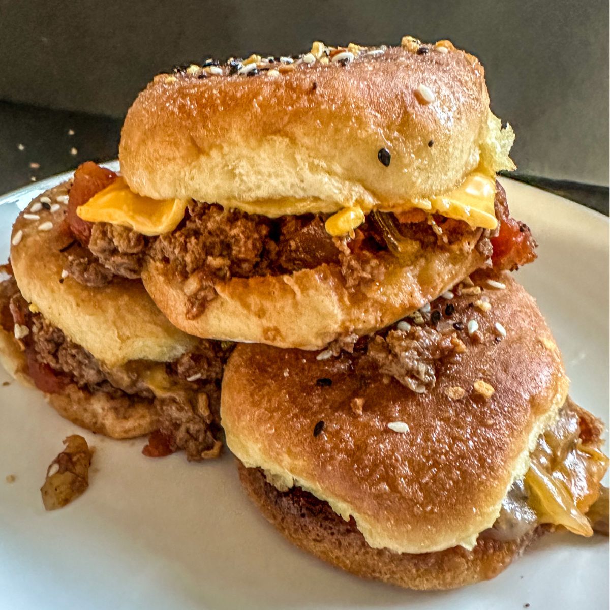 Three Sloppy Joe Sliders stacked on top of each other.
