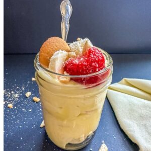 Jar of Strawberry Banana Pudding with a spoon.