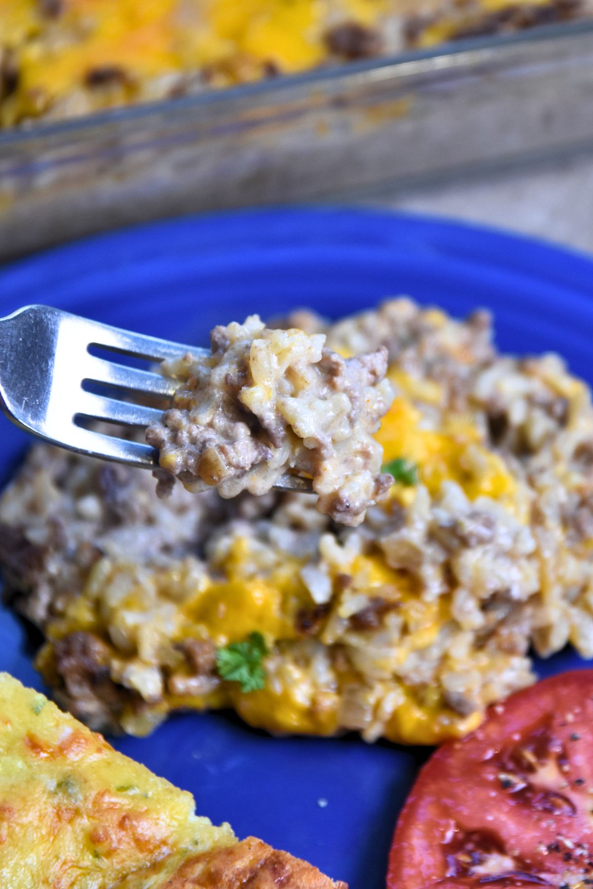 ranch-rice-casserole-on-a-fork Eating a bite of cheesy ranch ground-beef-and-rice casserole.