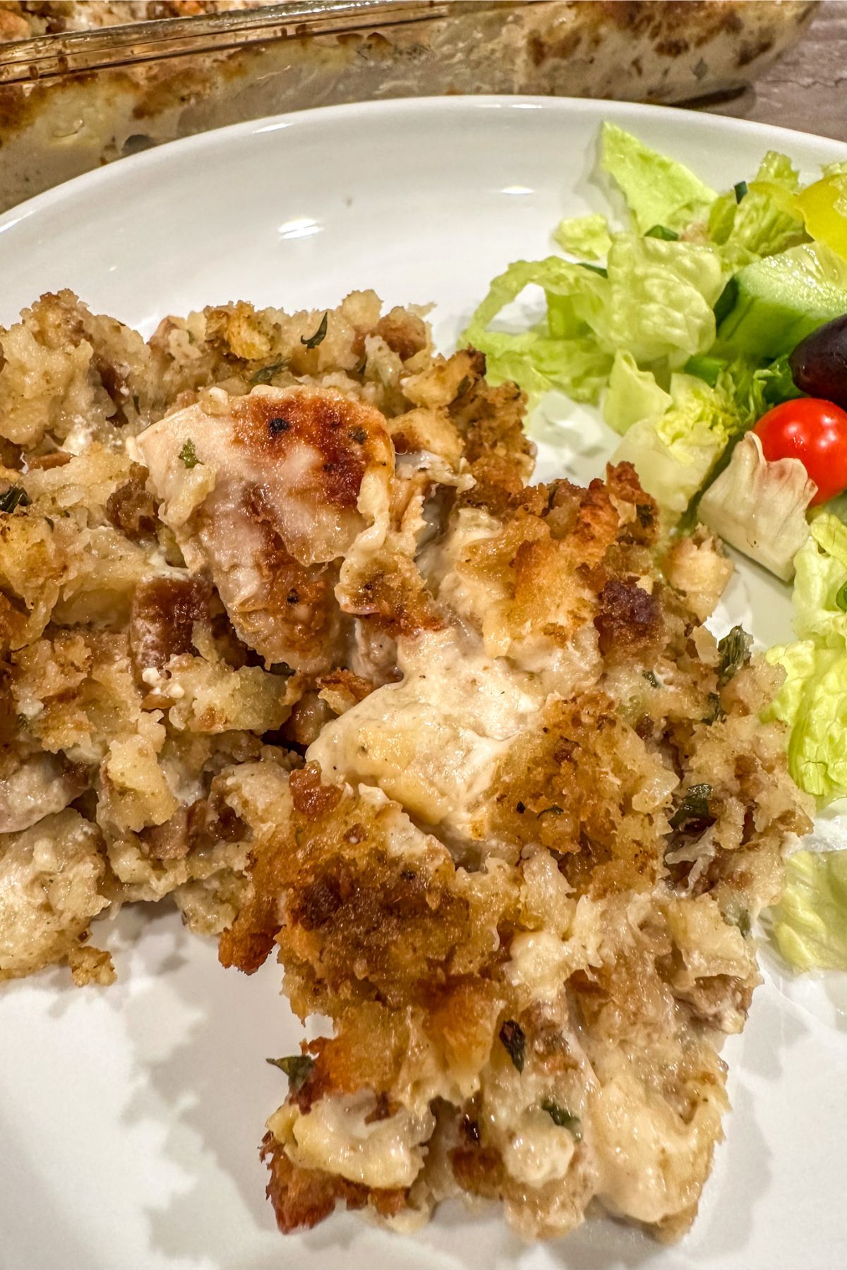 Rotisserie Chicken and Stuffing Casserole served on a dish with a salad.