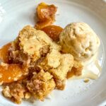 Serving of Peach Cobbler on a plate.