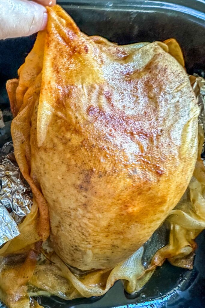 draping the cheese cloth on the turkey.