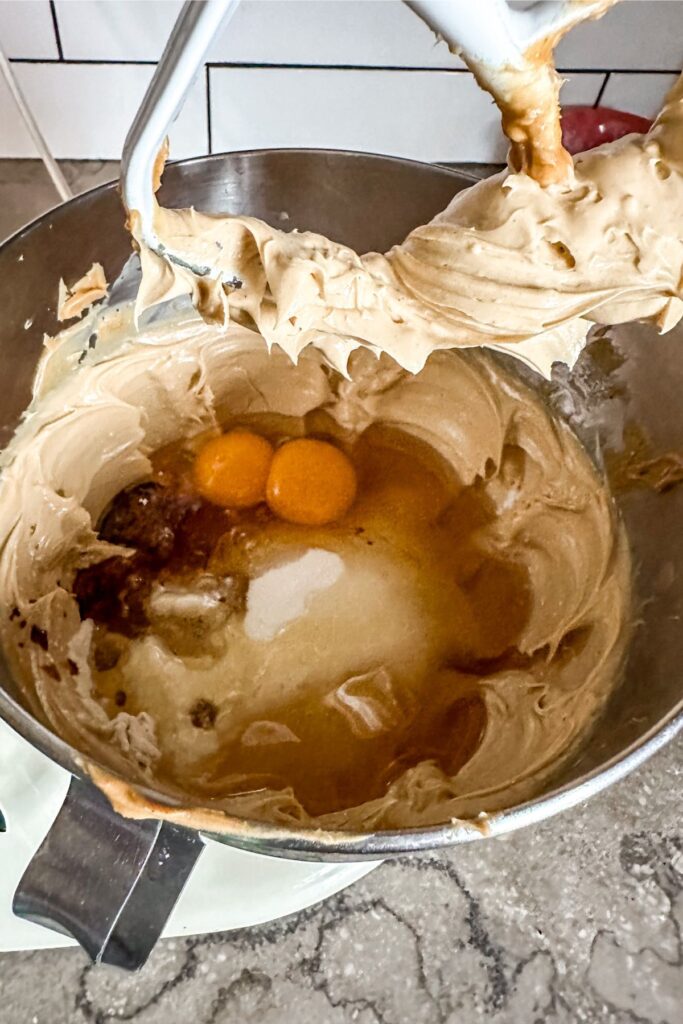 adding eggs and honey into honey peanut butter cookies mixture.