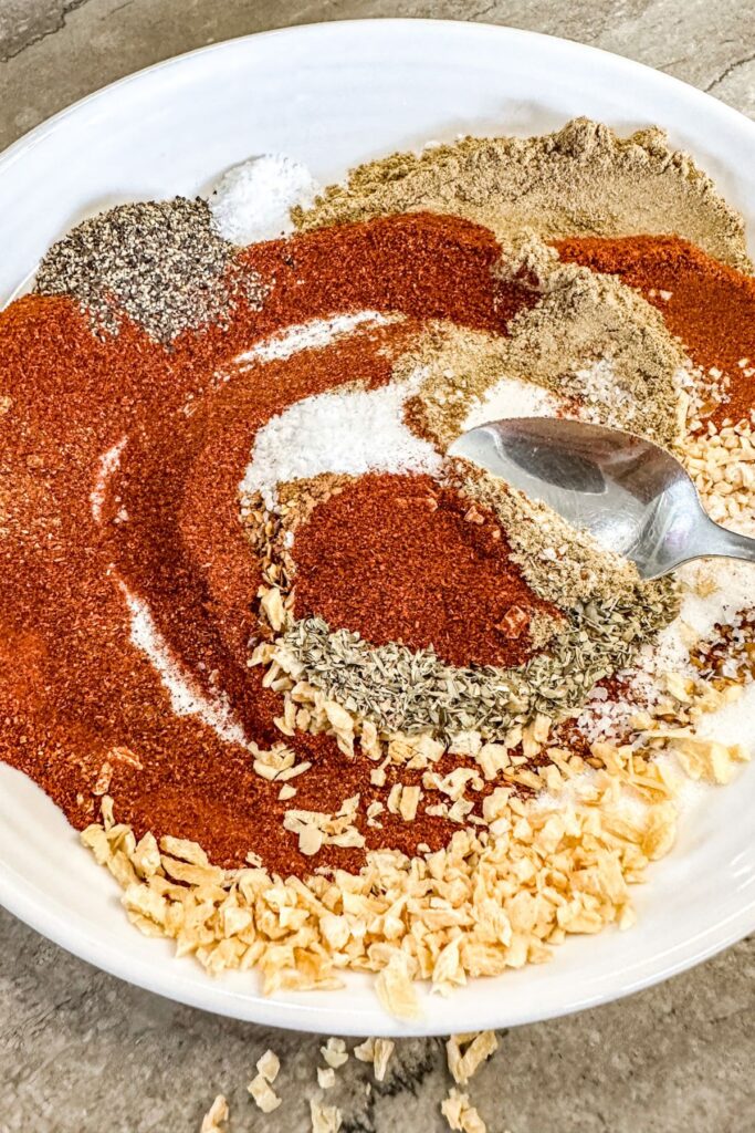 mixing all of the seasonings for chicken taco seasoning.