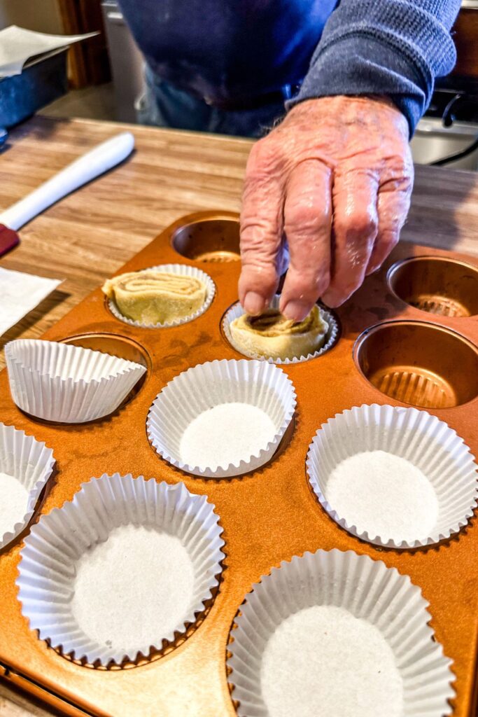placing the butts of the roll into a muffin tin.