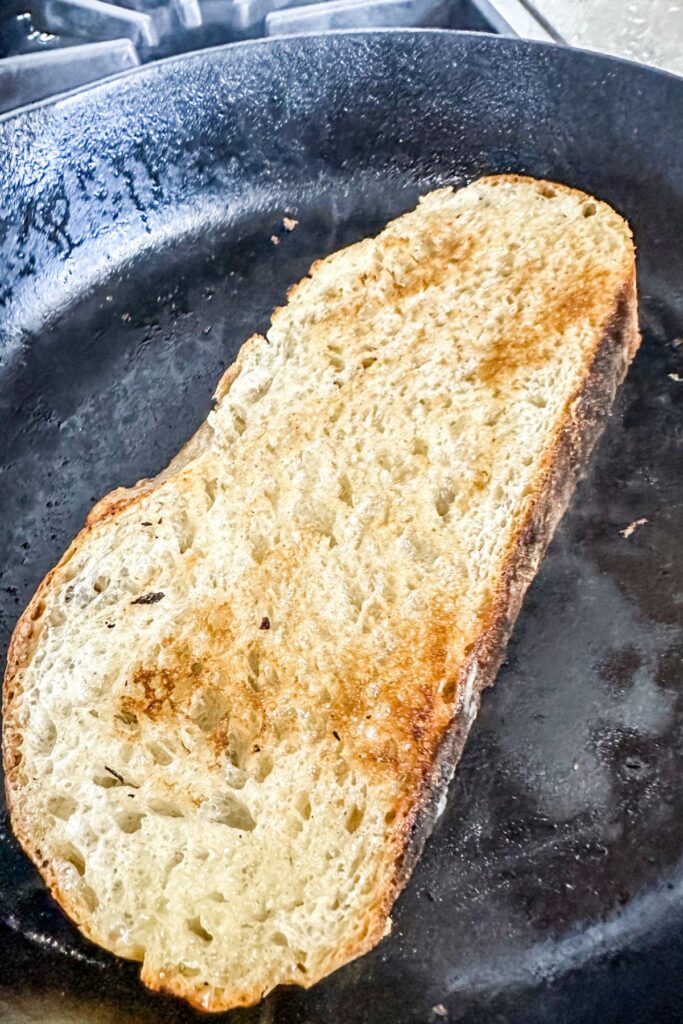 toasting the toast in an iron skillet.