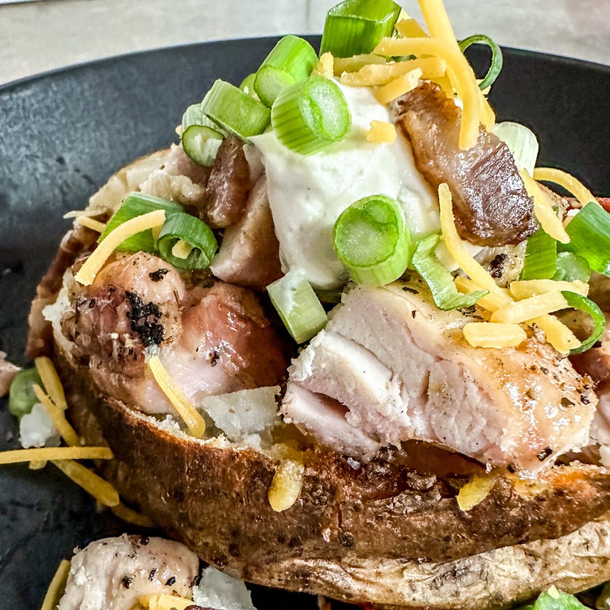 chicken bacon ranch baked potatoes with green onions.