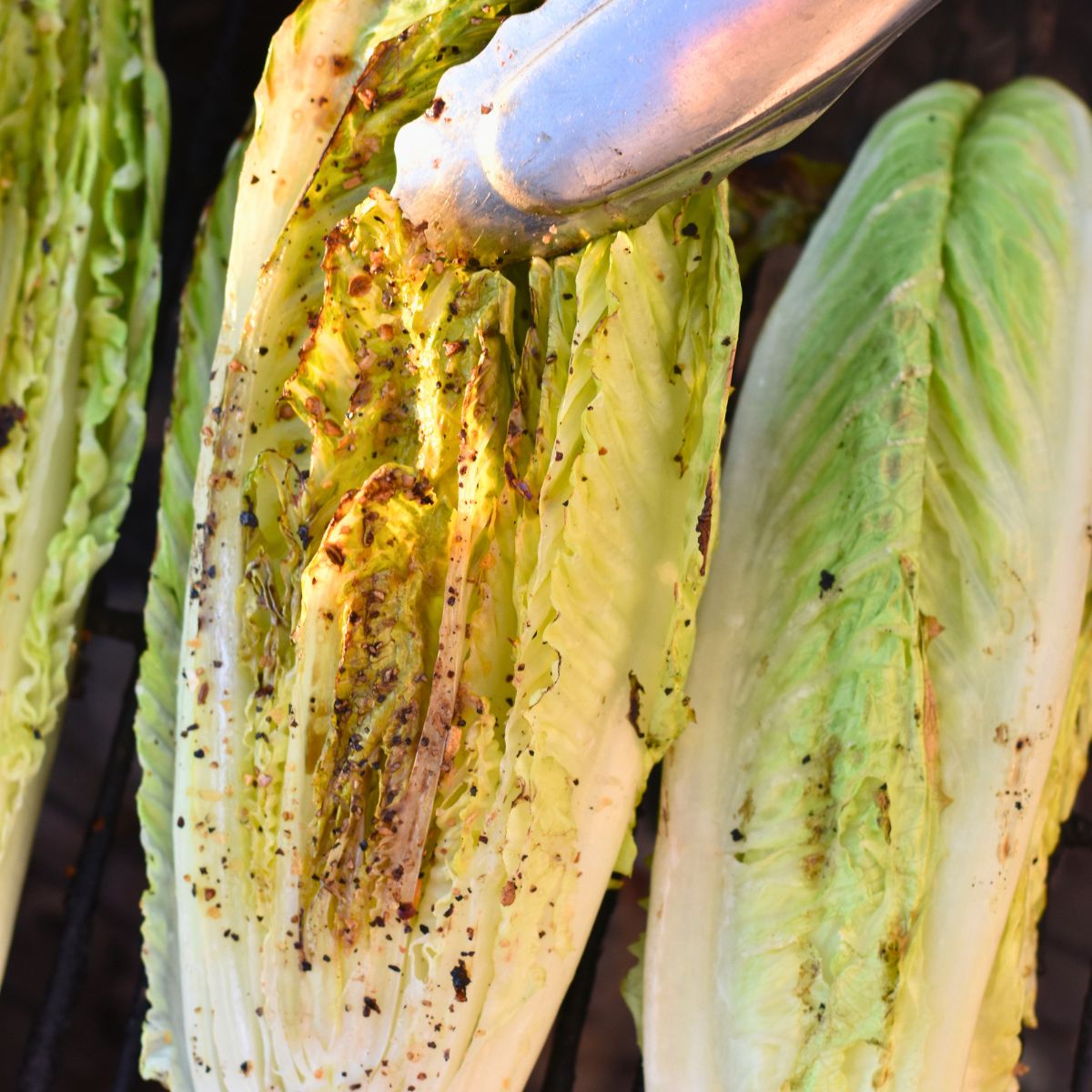 roasted-romaine-lettuce-on-a-grey-plate Flipping roasted romaine on the grill.