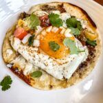 sausage breakfast smash taco on a white plate.