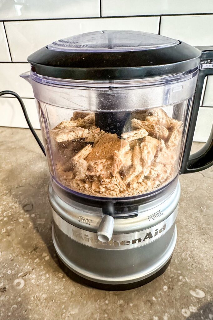 crushing-the-graham-crackers-in-a-KitchenAid-food-processor Crushing graham crackers for the crust on the chocolate cream pie.