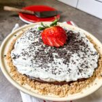 Chocolate cream pie topped with whipped cream and chocolate shavings.