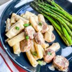 cheesy kielbasa pasta served with asparagus.