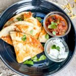 Cheese Crusted Quesadilla served with sour cream and salsa.