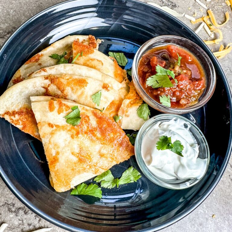 Cheese Crusted Quesadilla served with sour cream and salsa.