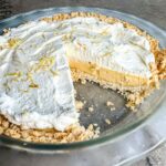 Finished lemon pie topped with homemade whipped cream.
