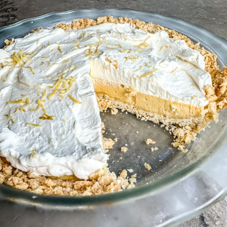 Finished lemon pie topped with homemade whipped cream.