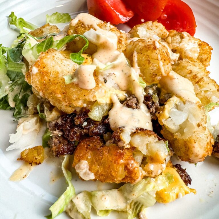 Big Mac Tater Tot Casserole served with a tomato.