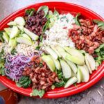 Baby shower salad finished and served on a red platter.