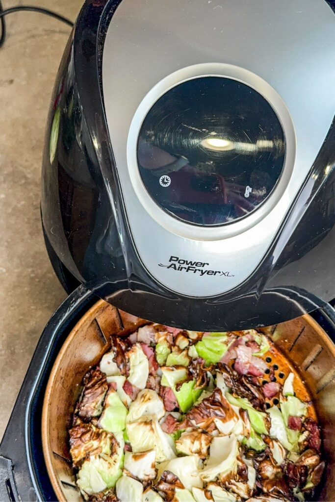 removing the cabbage from the air fryer.