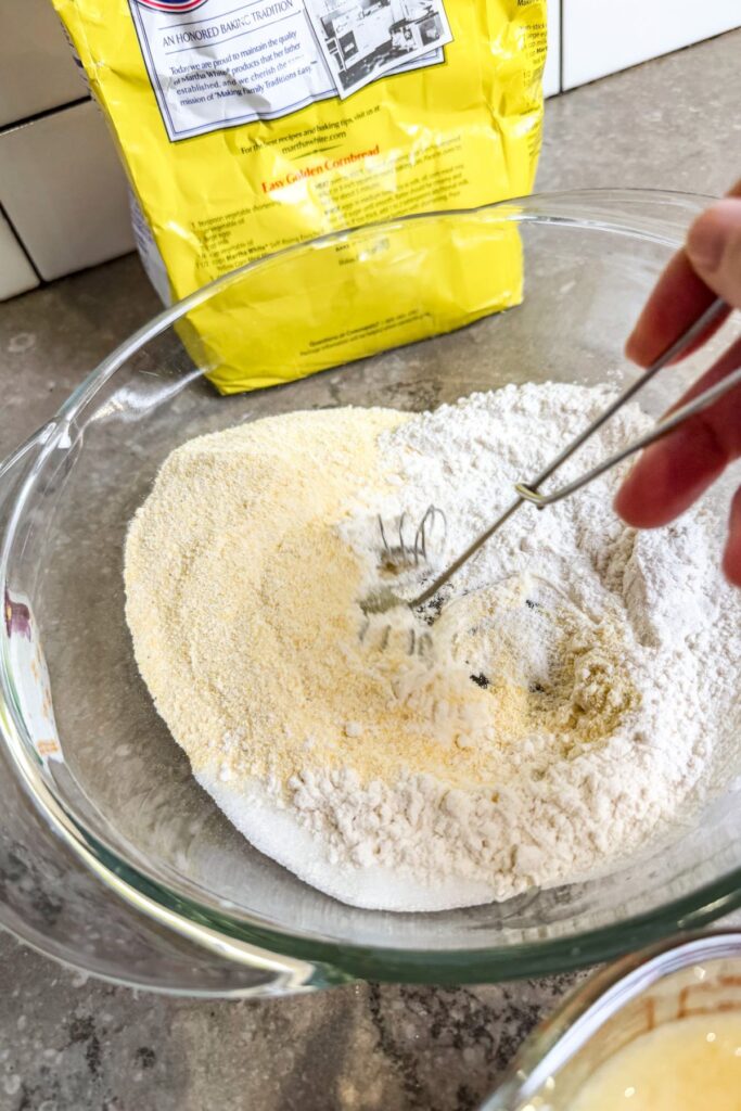 whisking the dry ingredients for cornbread sticks.