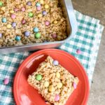 cutting the M&M rice krispie treats and serving them.
