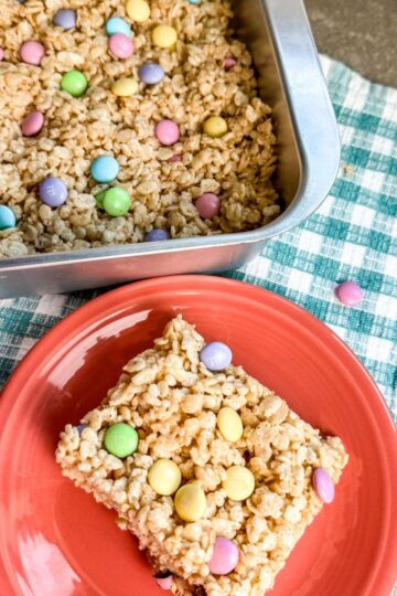 cutting the M&M rice krispie treats and serving them.