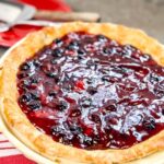A beautiful Blueberry Strawberry Pie with a glossy finish.