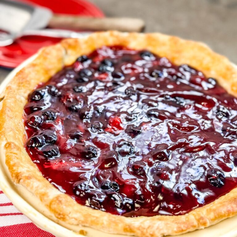 A beautiful Blueberry Strawberry Pie with a glossy finish.