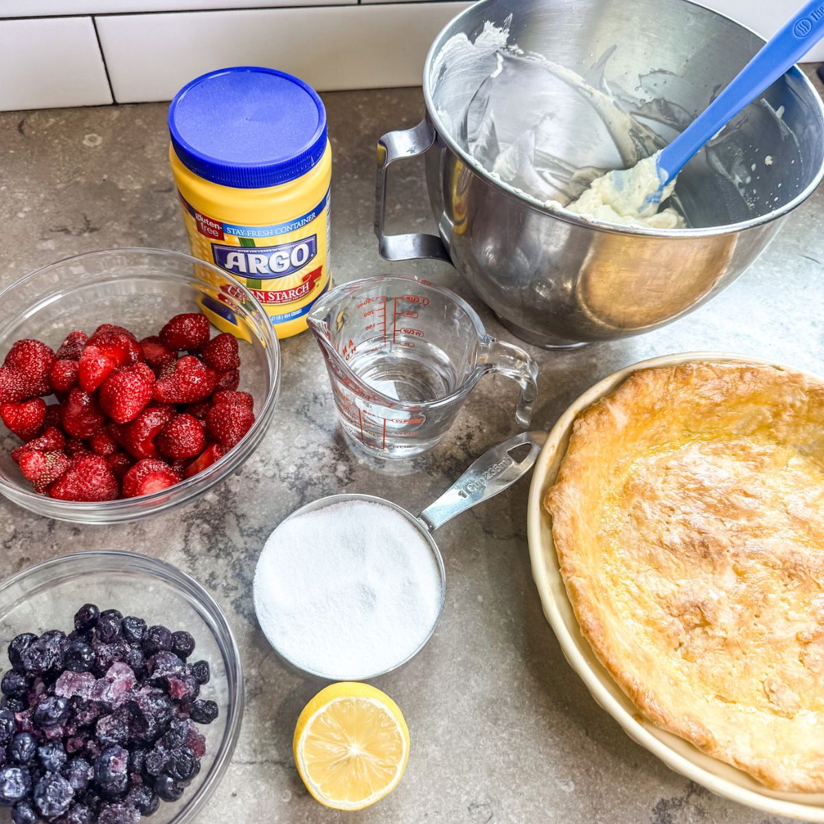 Ingredients needed to make a delicious blueberry strawberry pie.