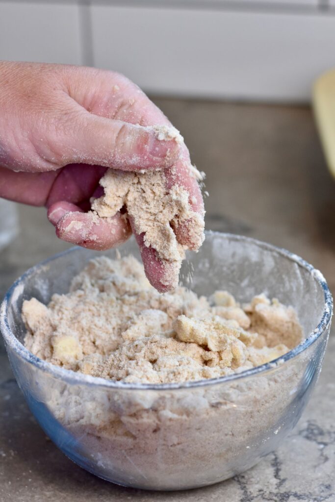 Smooshing butter, flour, and cinnamon