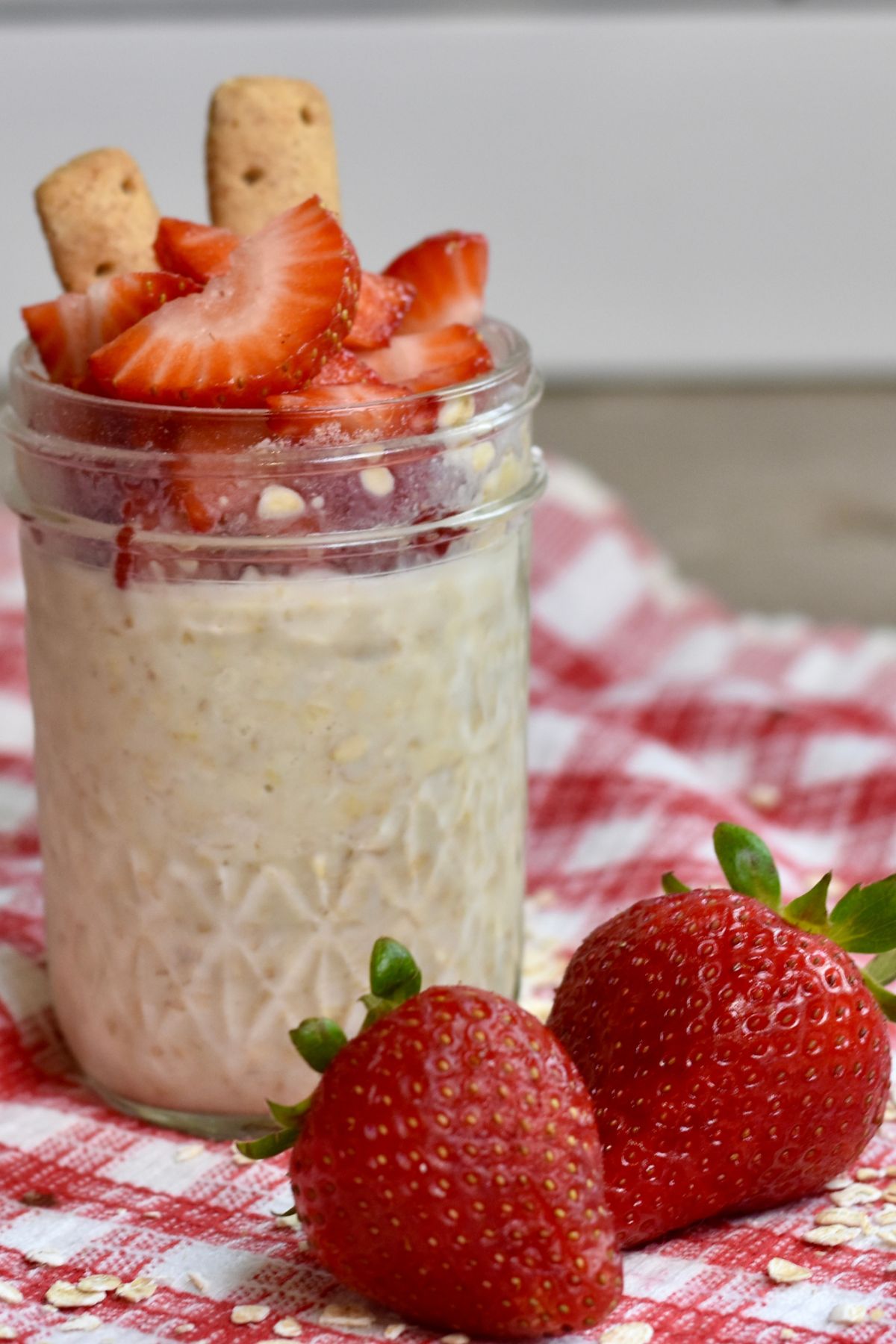 Serving the overnight oats with strawberries and graham crackers on top.