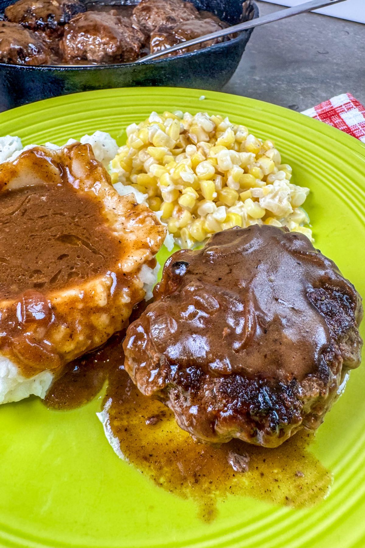 ready-to-eat-hamburger-steaks-served-on-a-green-plate serving the oven baked hamburger steaks to guest.