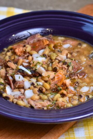 topping the peas with onions and hot sauce.