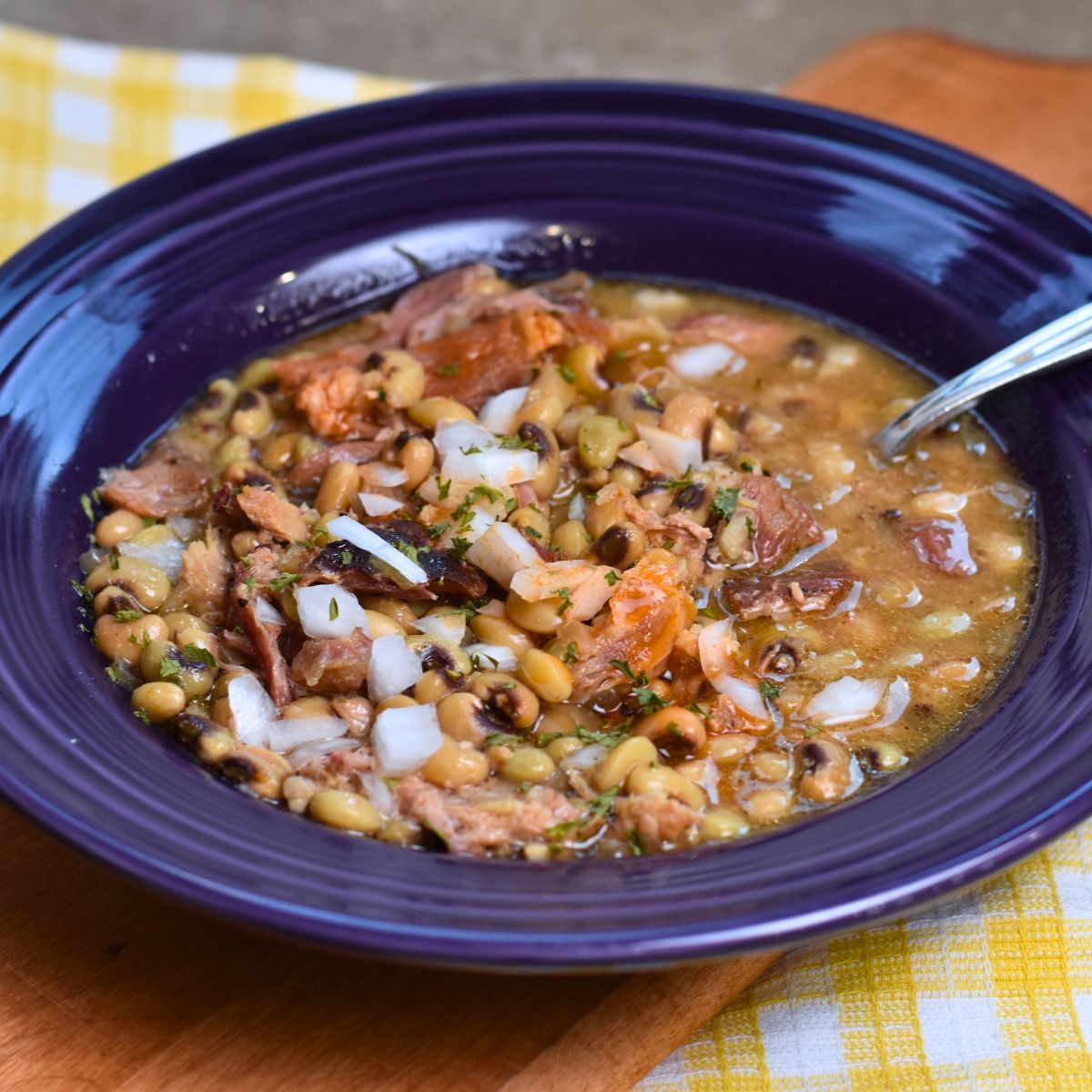 yellow-and-brown-purple-hull-peas topping the peas with onions and hot sauce.